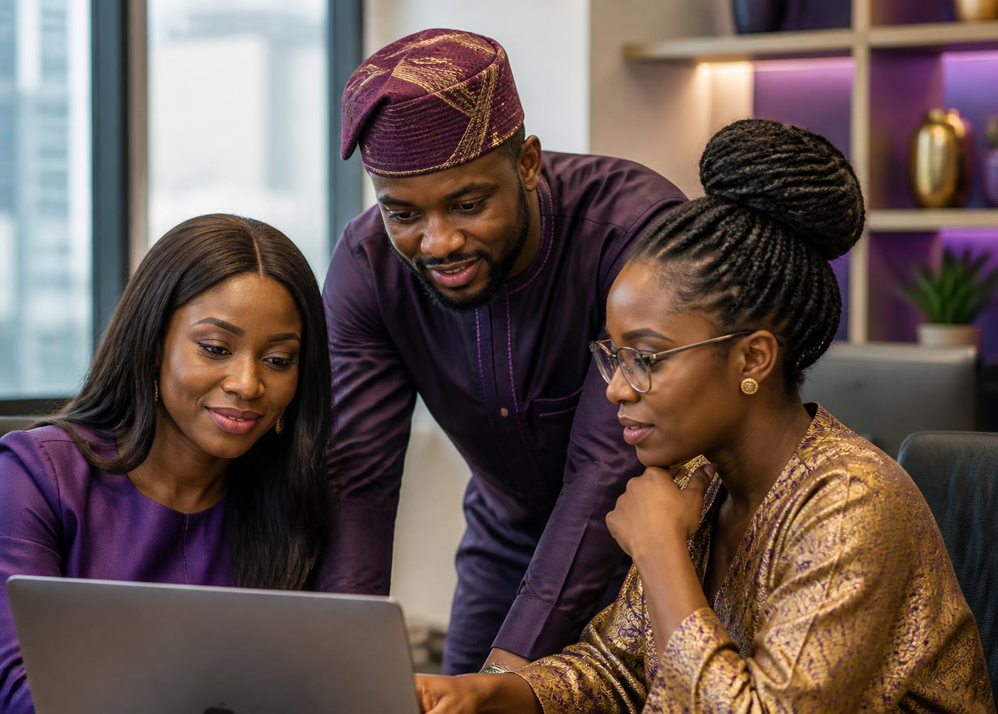 Three colleagues reviewing staff leave together in a Lagos office